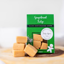 Gingerbread fudge with a green packaging box on a wooden surface