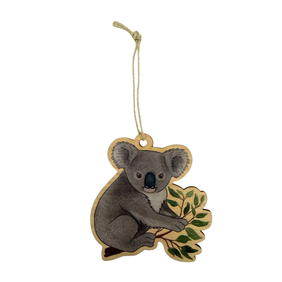 Decorative hanging ornament of a koala with a leaf on a white background