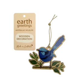 Wooden decoration of a blue wren bird on a branch with 'earth greetings' packaging.