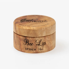 Wooden lip balm container with 'Bee Lips' branding on a white background