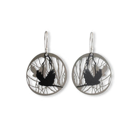 Pair of earrings with black cockatoo bird silhouette design on a white background