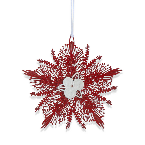 Red bottlebrush  ornament with a white center on a white background