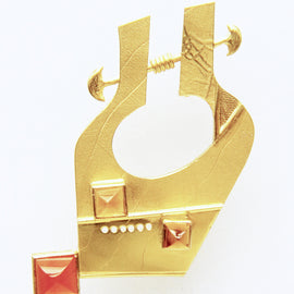 Image of a gold brooch on a white background