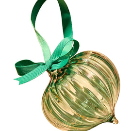 Decorative glass ornament with a green ribbon on a white background