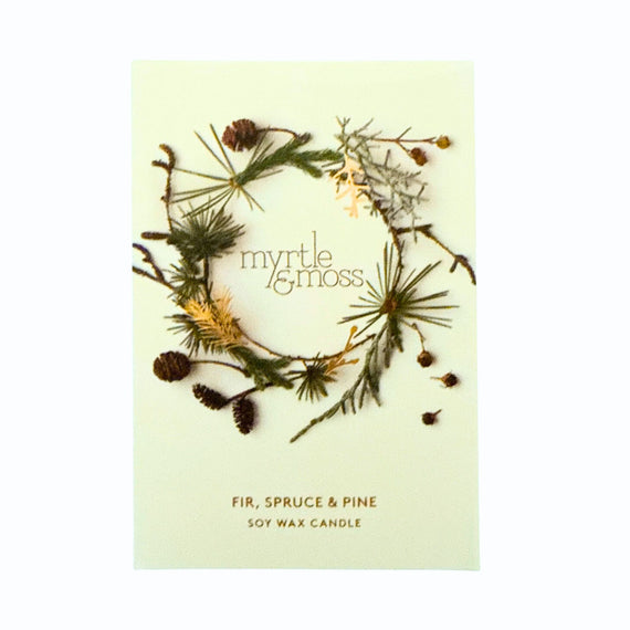 Candle packaging with greenery and 'myrtle & moss' branding on a light background