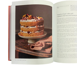 Open book showing a recipe for a layered cake with text on a white background