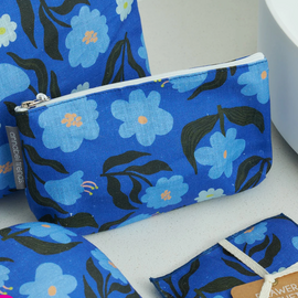 Blue floral patterned pouches on a white surface