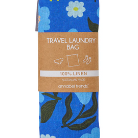 Blue floral travel laundry bag with a brown label on a white background