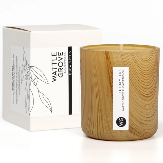 Wooden candle with Wattle Grove branding next to its packaging on a white background
