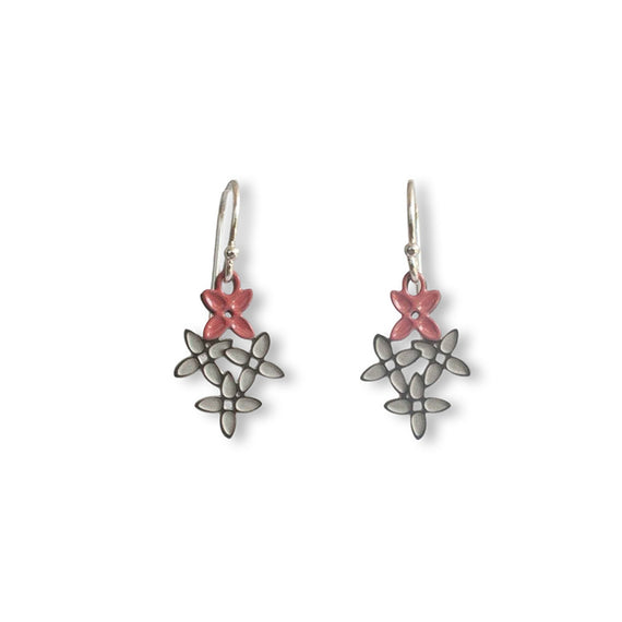 Pair of earrings with pink floral tops and silver leaf-like bottoms on a white background