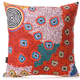 Decorative pillow with a vibrant, indigenous art on a white background
