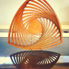 Wooden spiral sculpture on a reflective surface with a neutral background