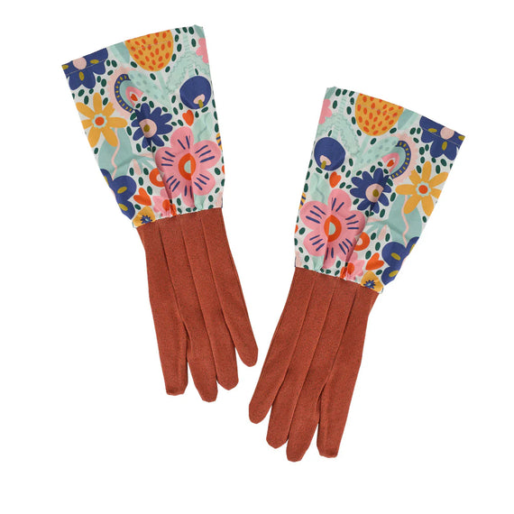 Pair of gloves with colorful floral pattern on cuffs against a white background