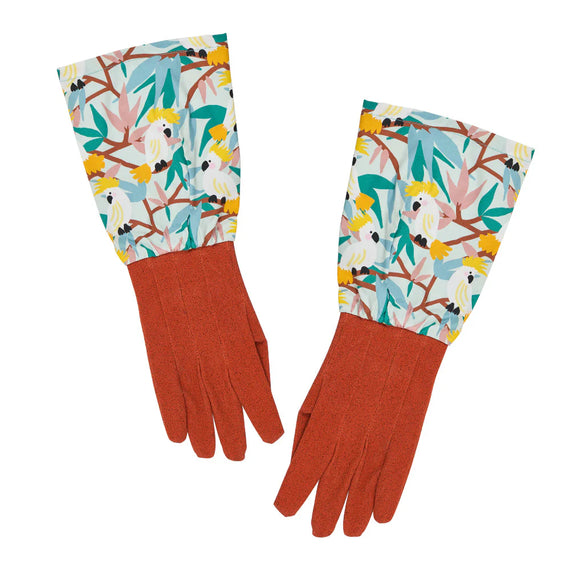 Pair of gloves with a colorful cockatoo pattern on a white background