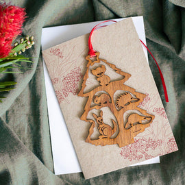 A decorative Christmas tree card made of wood, featuring a Christmas tree with animals.