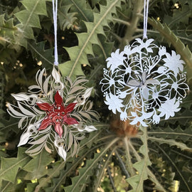  red and silver metal Christmas ornament shaped like a Sturt Pea flower with a powder-coated finish, tied with string.
