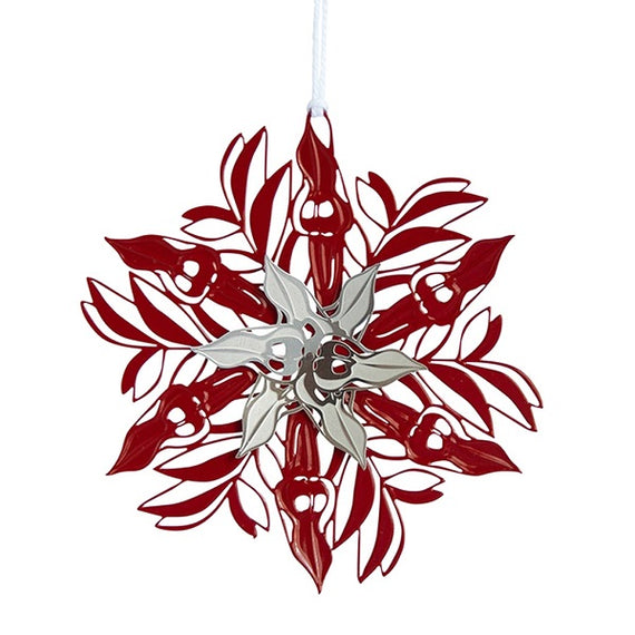 A red and silver metal Christmas ornament shaped like a Sturt Pea flower with a powder-coated finish, tied with string.